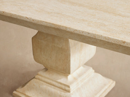 Light beige Primrose Outdoor Dining Table with rectangular top, two pedestal bases, on a pale tiled patio.