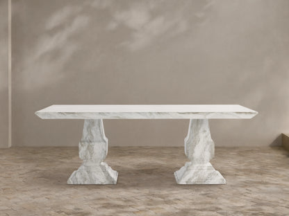 Primrose Outdoor Dining Table with rectangular white-grey marbled top and two sculpted pedestal bases on a tiled patio.