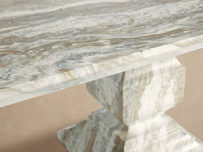 Primrose Outdoor Dining Table, rectangular light gray GFRC with natural stone-like grey veining, two sculpted pedestal bases on patio.