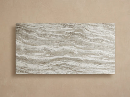 Close-up of Primrose Outdoor Dining Table showing its white, grey, and brown veined natural stone-look top and sculpted base.