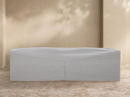 Light grey Puglia Outdoor Collection Covers on a sofa, chaise, and armchair on a stone patio.