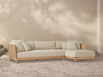 Puglia Outdoor Teak Two-Piece Sectional with right-hand chaise, light cream cushions, natural teak frame, and woven accents.