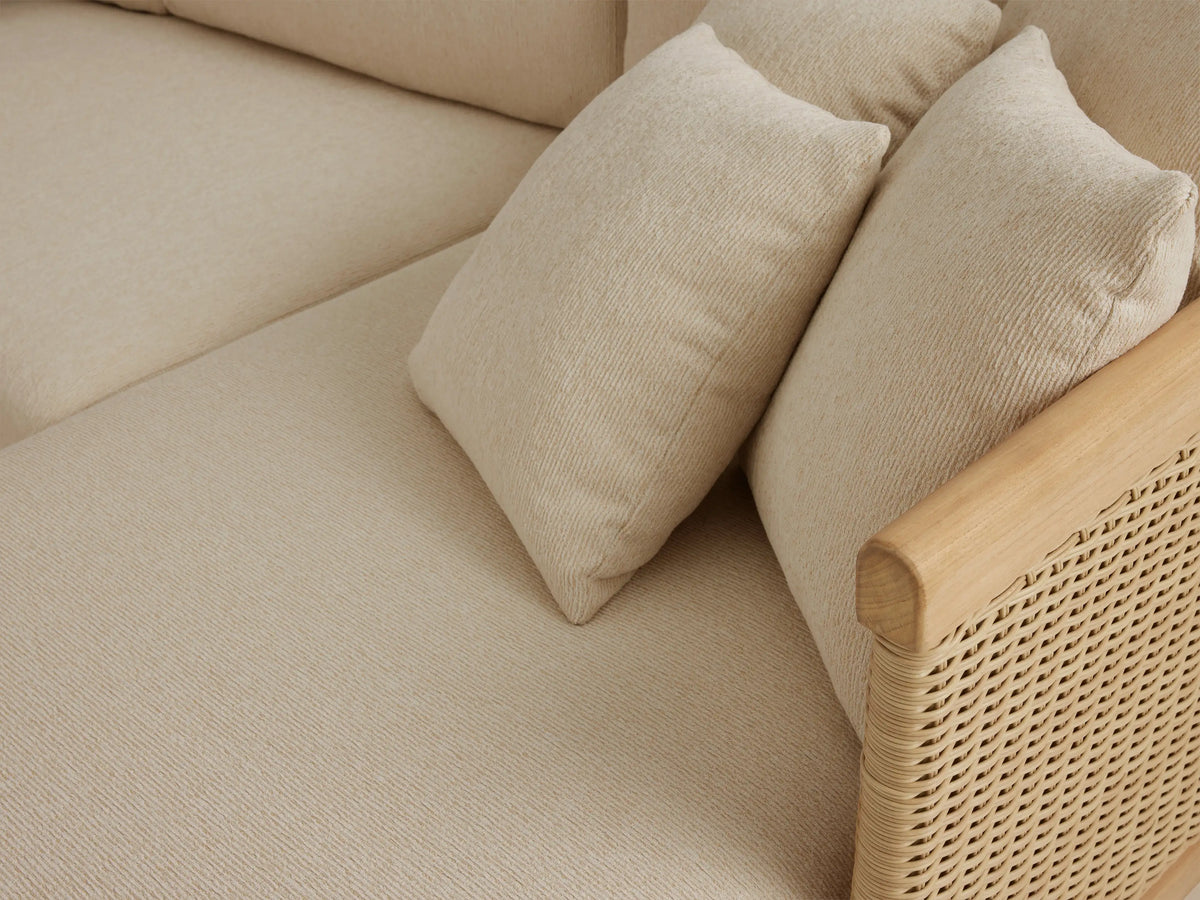 Puglia Outdoor Teak Sectional: L-shaped, light beige cushions, natural teak frame, woven sides, right chaise on a patio.