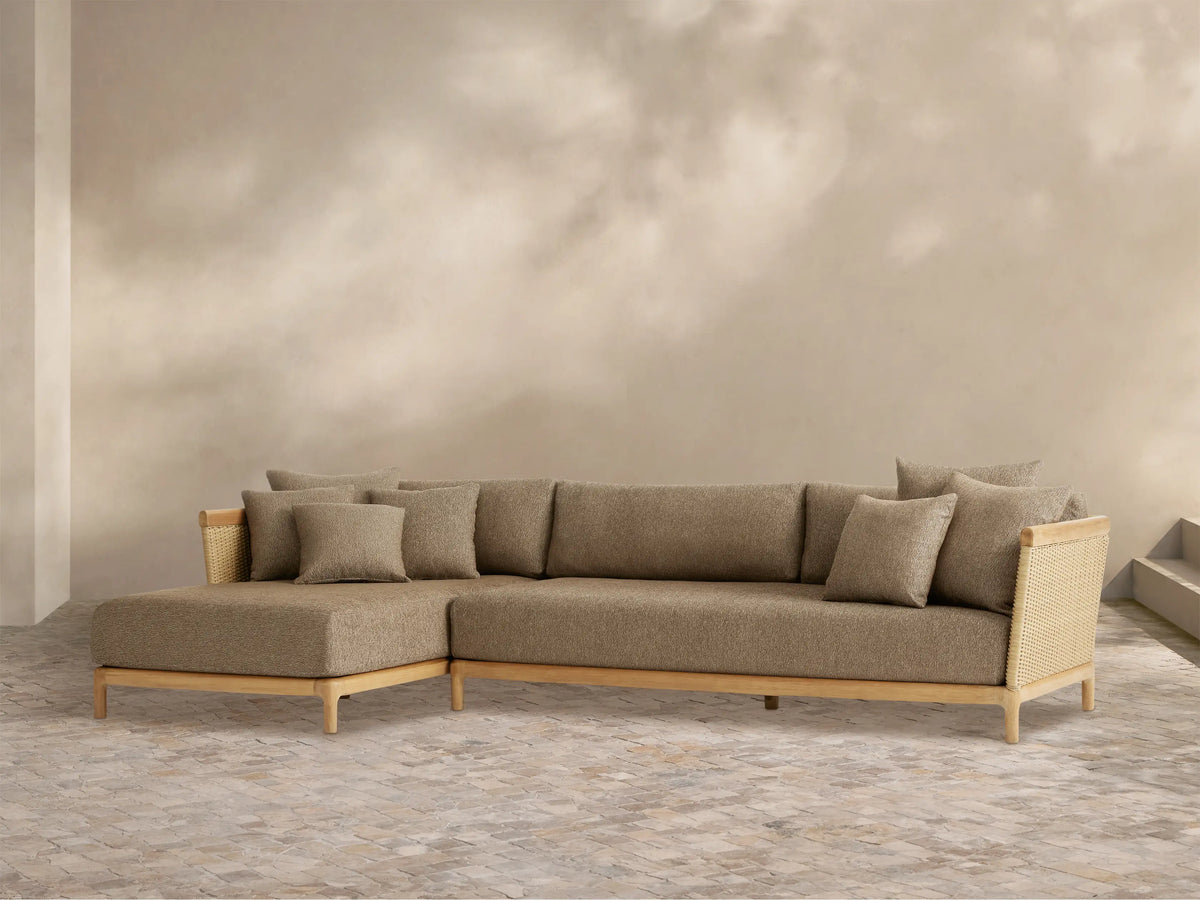 Puglia Outdoor Teak Two-Piece Sectional with Chaise. L-shaped, light teak frame with woven ends, textured brown cushions.