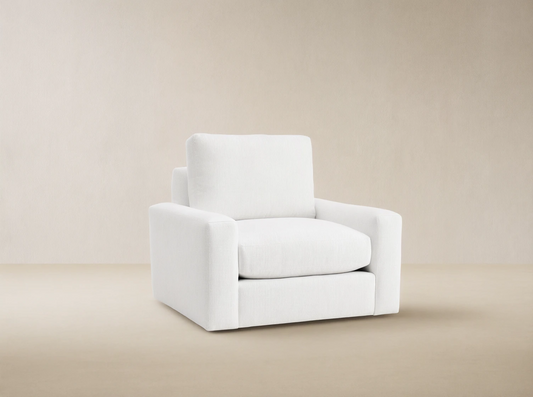 Remington Outdoor Swivel Chair in Eden Snow, a white modern outdoor swivel armchair with thick cushions & wide arms on light floor.