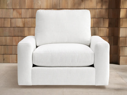 Remington Outdoor Swivel Chair in Eden Snow, a white modern outdoor swivel armchair with thick cushions & wide arms on light floor.