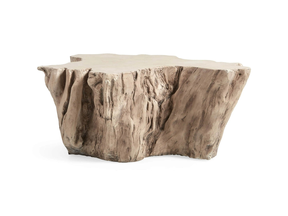 Root Outdoor Bleached Coffee Table resembling a natural tree root, with a smooth, textured surface against a coastal background.