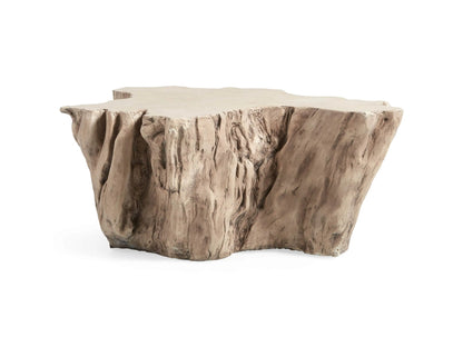 Root Outdoor Bleached Coffee Table resembling a natural tree root, with a smooth, textured surface against a coastal background.