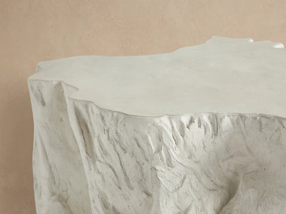 Root Outdoor Bleached Coffee Table: Irregular, off-white, textured concrete coffee table with organic, tree root-like sides.
