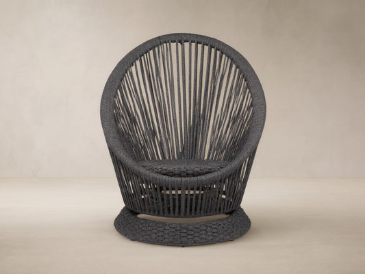Dark gray Sevilla Outdoor Swivel Chair, round high-back design, woven polyester rope with vertical patterns, textured swivel base.