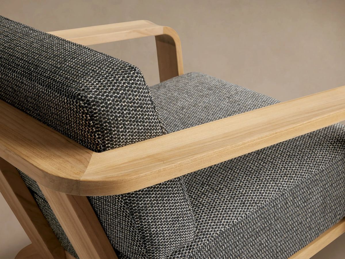 Sonoma Outdoor Teak Lounge Chair, light natural teak wood frame with wide armrests, dark grey textured cushions, front view.