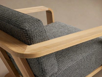 Sonoma Outdoor Teak Lounge Chair, light natural teak wood frame with wide armrests, dark grey textured cushions, front view.