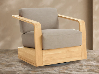 Sonoma Outdoor Teak Swivel Chair with light natural teak frame & light gray cushions, angled view on tiled patio.