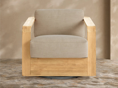 Sonoma Outdoor Teak Swivel Chair with light natural teak frame & light gray cushions, angled view on tiled patio.