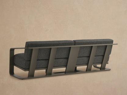 Sonoma Outdoor Aluminum Sofa, close-up. Dark gray textured cushions, multi-tone weave. Bronze aluminum frame and armrest.