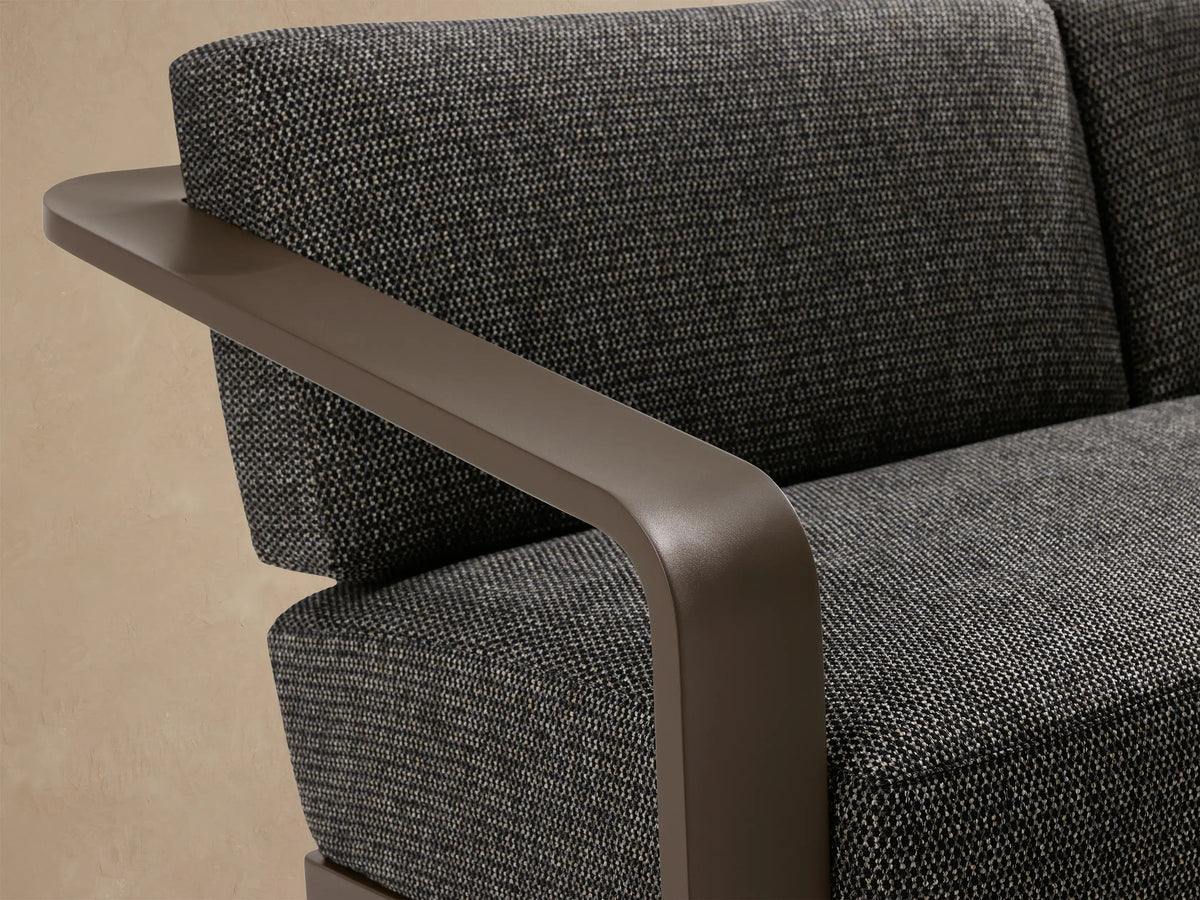Sonoma Outdoor Aluminum Sofa with dark gray cushions and a bronze-colored aluminum frame, angled right on a tiled patio.
