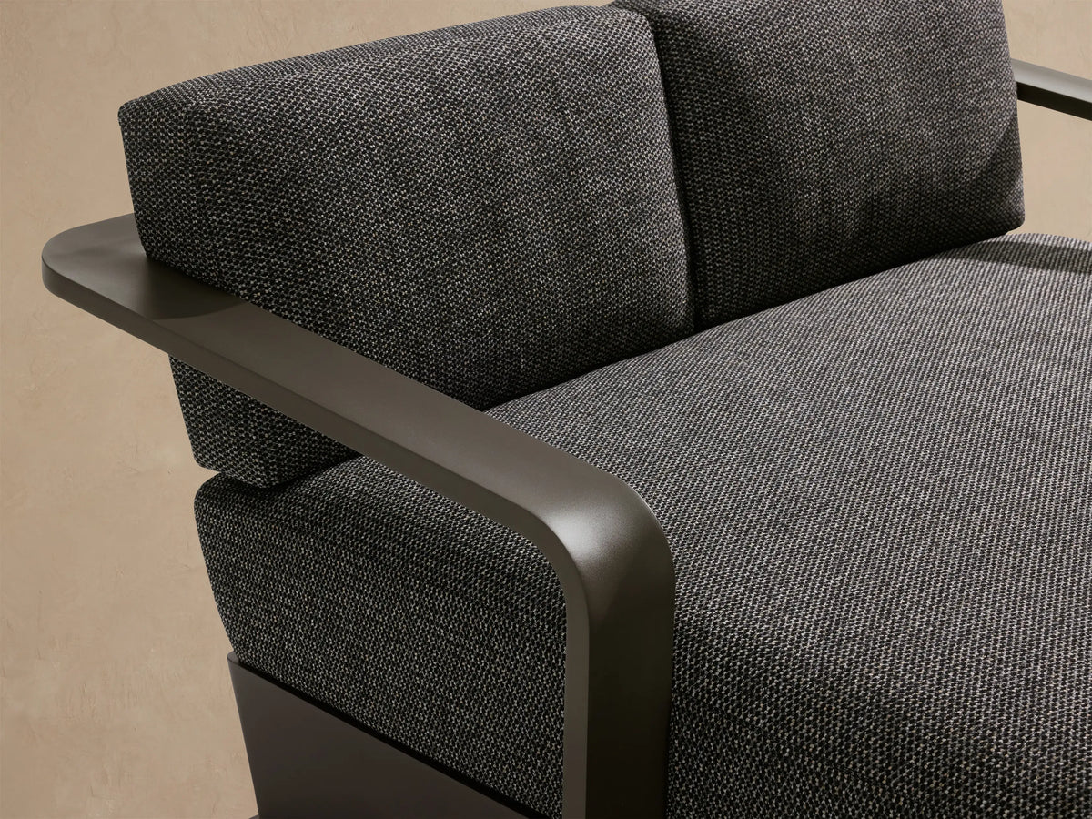 Sonoma Outdoor Aluminum Daybed, dark gray with a speckled fabric cushion and a powder-coated aluminum frame, side view.