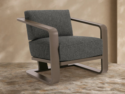 Sonoma Outdoor Aluminum Lounge Chair with dark taupe frame & dark gray textured cushions, viewed from front-right on a stone patio.