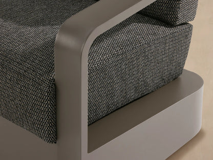 Front view of Sonoma Outdoor Swivel Chair. Powder-coated gray aluminum frame, charcoal gray woven cushions on a light stone patio.