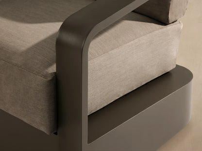 Front view of Sonoma Outdoor Aluminum Swivel Chair with a taupe frame and light beige cushions. Sits on a stone patio.