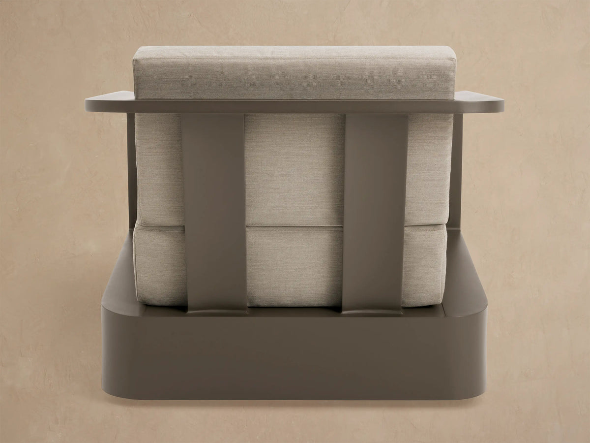 Sonoma Outdoor Aluminum Swivel Chair, angled back. Dark bronze frame, light beige cushions, flat armrests, slatted back.