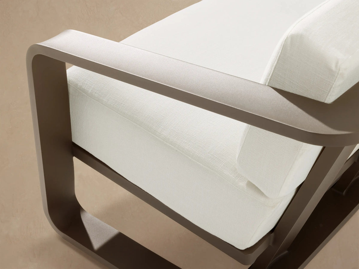 Sonoma Outdoor Aluminum Sofa, 2-seater, with white cushions and a dark bronze aluminum frame on an outdoor patio.
