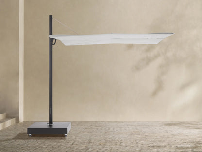 Closed Spectra Outdoor Square Umbrella, light off-white canopy, dark gray frame & wheeled base, against a beige wall.