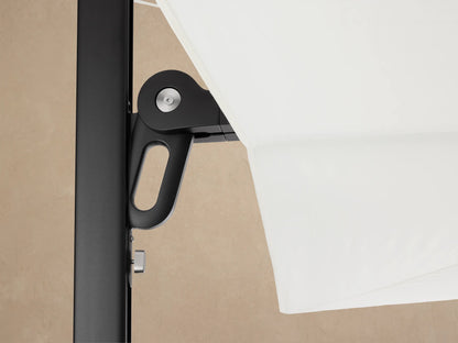 Spectra Outdoor Umbrella, closed and horizontal, with a distinct angular white canopy and black pole on a light beige background.