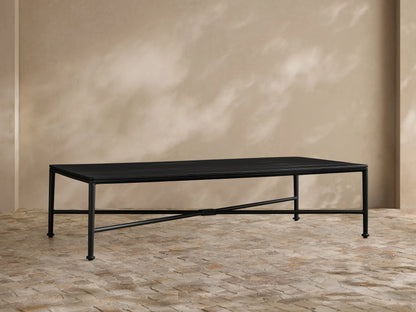 Front view of the dark brown slatted aluminum Surrey Outdoor Coffee Table on a patio rug.