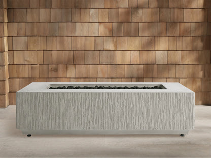 Wilmar Rectangular Natural Gas Fire Pit, gray concrete with textured sides, bright flames over black lava rock. Wooden shingle wall.