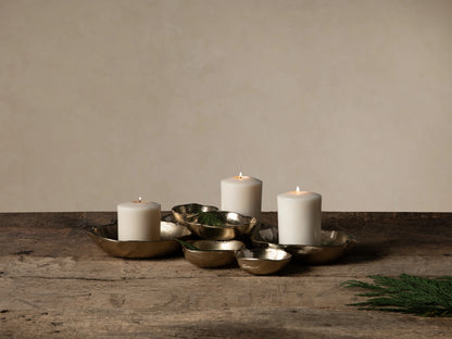 Collection of dark gold Klasa platters & bowls on wood. Large platter with figs, others with olives & grapes.