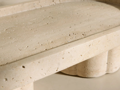Front view of the beige and ivory-toned Sylvaine Footed Tray with an oval top and two scalloped cylindrical feet.