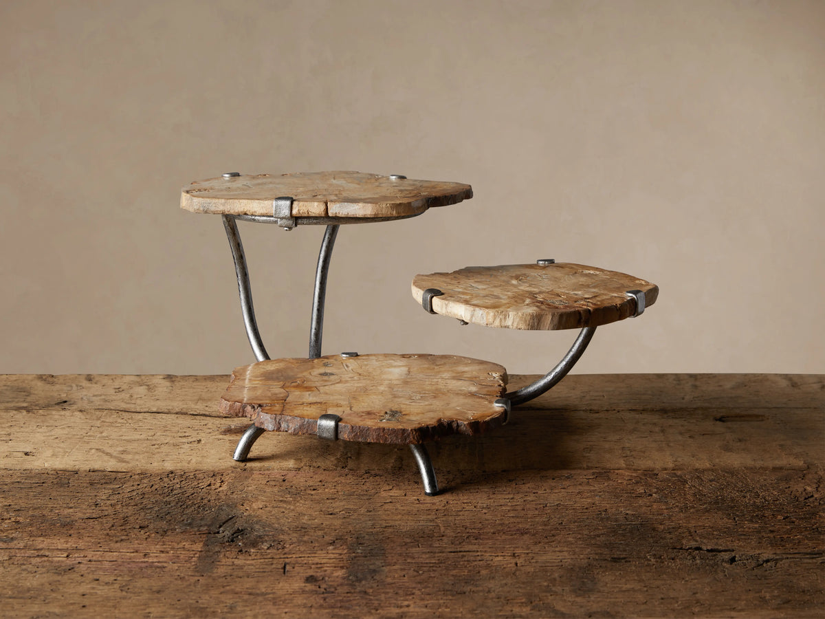 Natural Petrified Wood Triple Tray Server. Three organically shaped, light brown wood slices on dark grey metal supports.