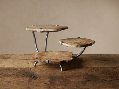 Natural Petrified Wood Triple Tray Server. Three organically shaped, light brown wood slices on dark grey metal supports.