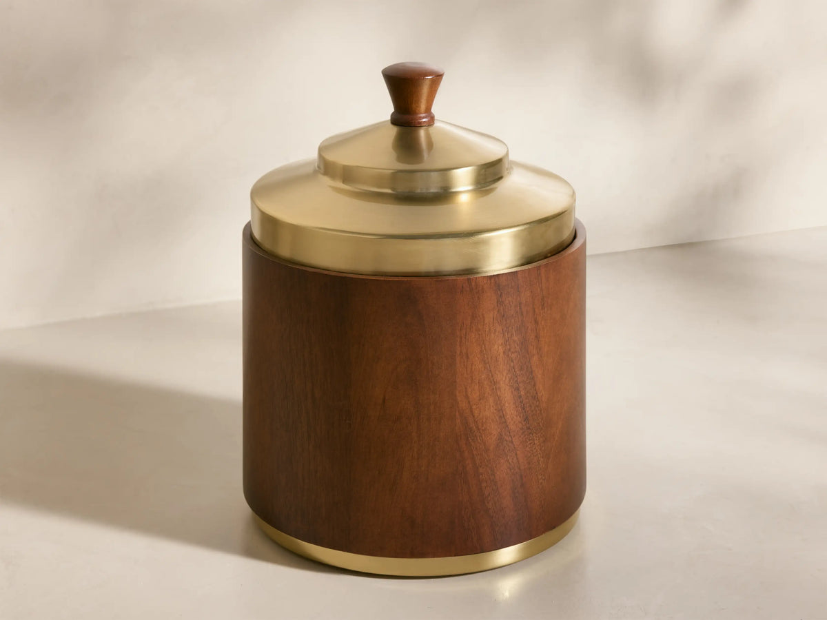 Front view of Errol Ice Bucket, dark brown wood body with a gold brass lid, wood knob handle, and brass base ring.