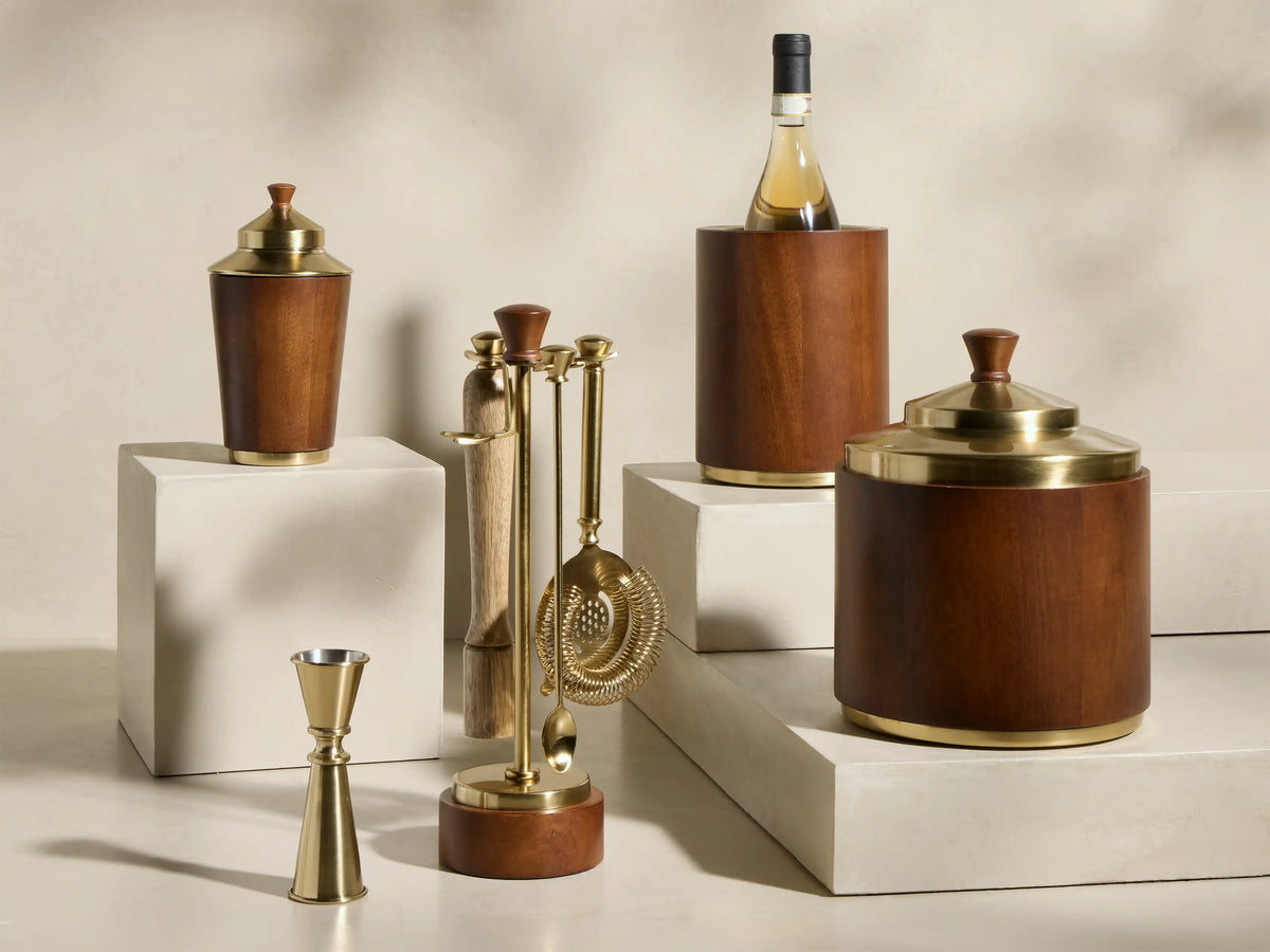 Close-up of the Errol Ice Bucket with a golden brass lid, a dark brown wooden knob, and a dark wood cylindrical body.