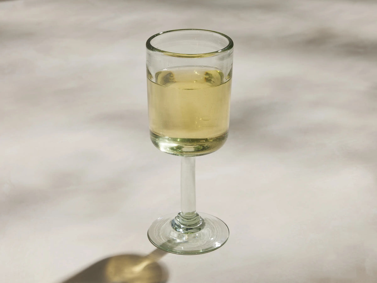 Single Granada Wine Glass, light green handblown recycled glass. Cylindrical body, softly squared top edge, and short stem.