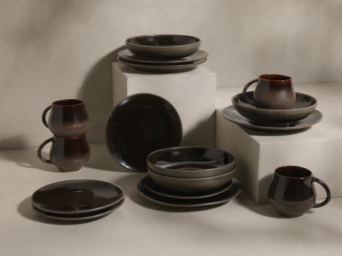 Full display of the chocolate and mocha Hearthline Dinnerware With Pasta Bowls (Set of 16) with reactive glaze.