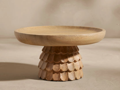 Light brown Kanga Pedestal Bowl, carved mango wood base with scaly texture, and a shallow round top.