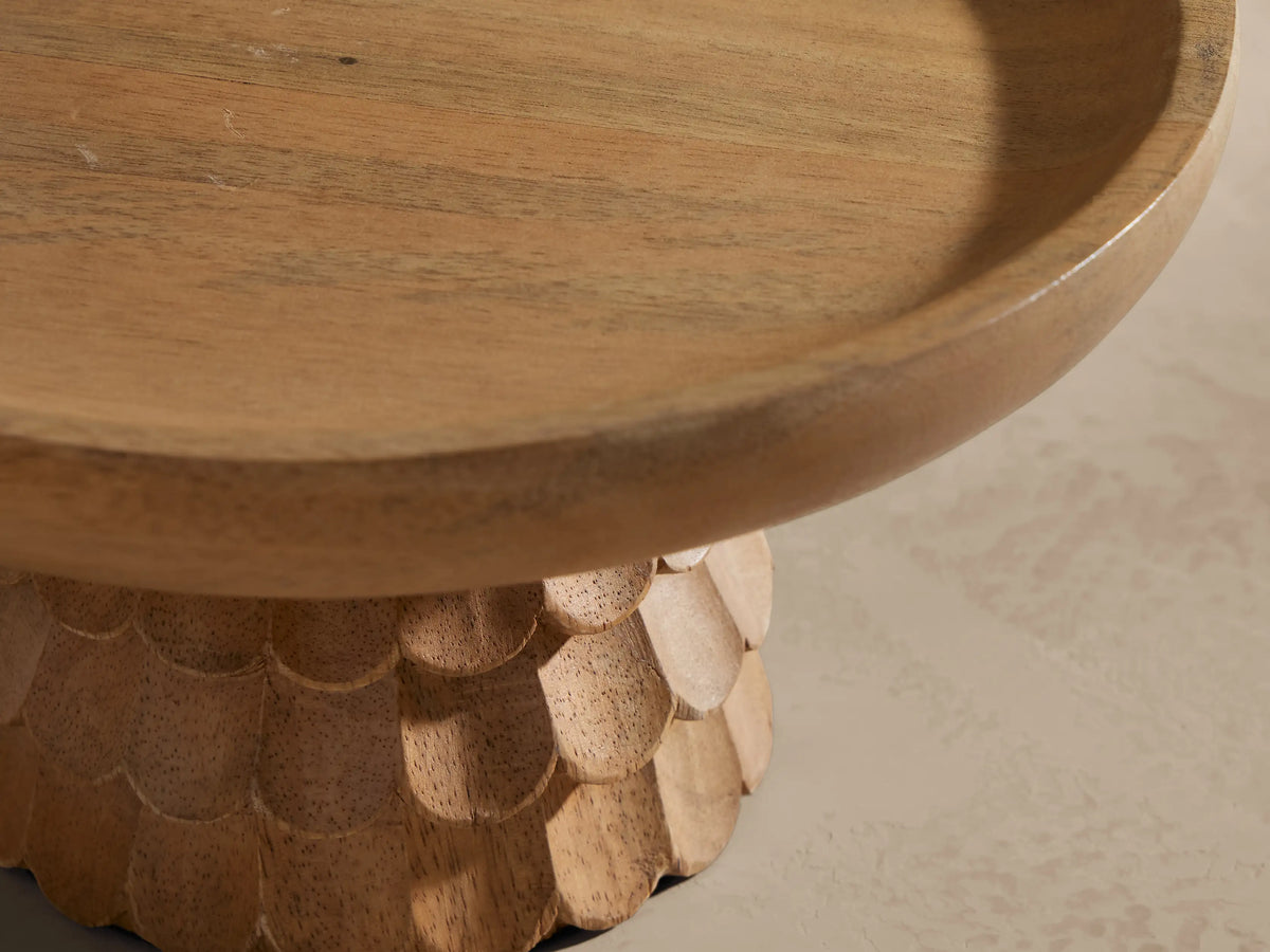 Light brown Kanga Pedestal Bowl, carved mango wood base with scaly texture, and a shallow round top.