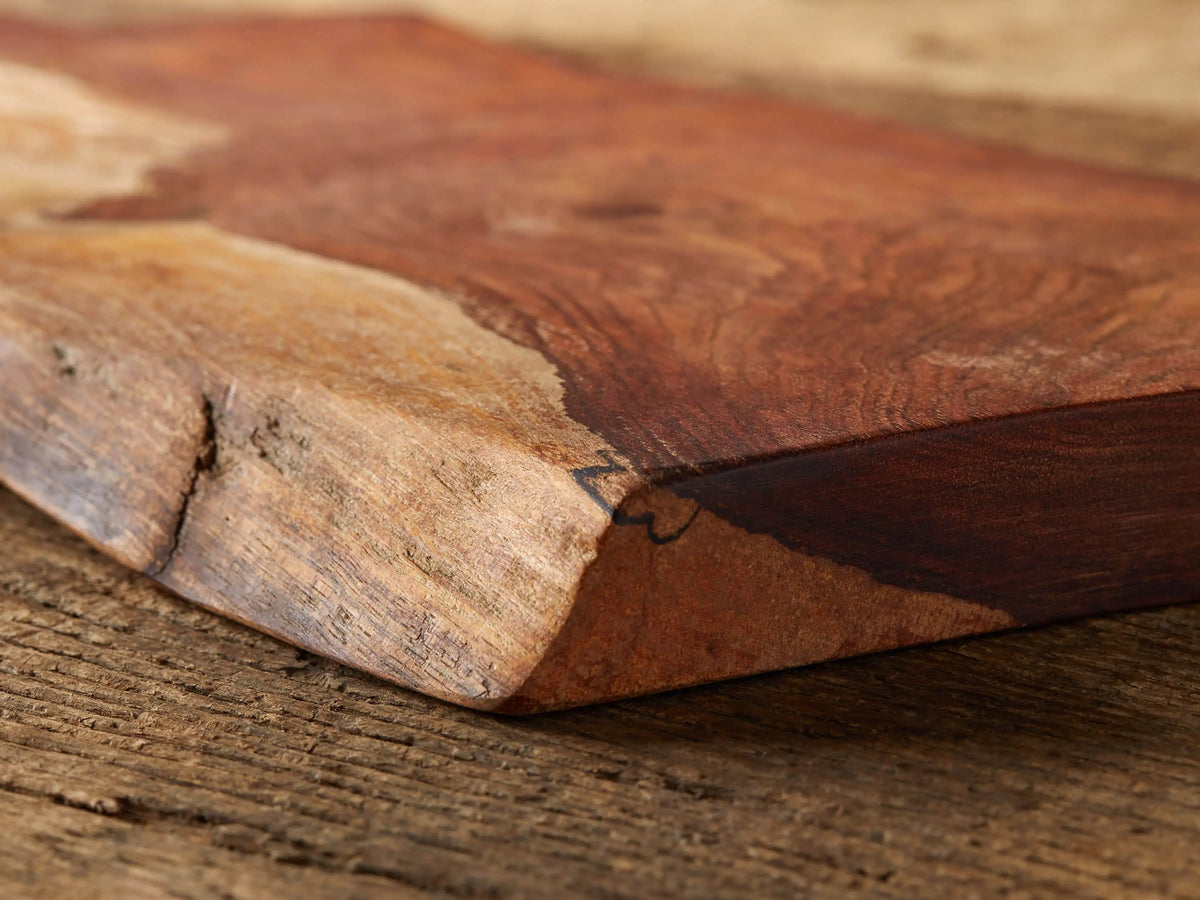 Rustic reclaimed wood cutting board with rich, natural grain patterns and color variations; features an oiled finish.