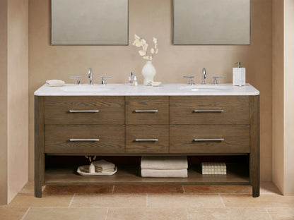Calista Double Vanity with oak wood finish, marble top, dual sinks, metal handles, soft-closing drawers, and open shelf below.