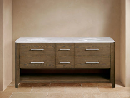 Calista Double Vanity with oak wood finish, marble top, dual sinks, metal handles, soft-closing drawers, and open shelf below.