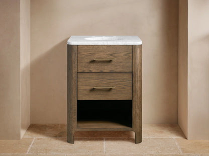 Calista Powder Vanity made of oak wood with two drawers, white stone top, brass hardware, and an oval undermount sink.
