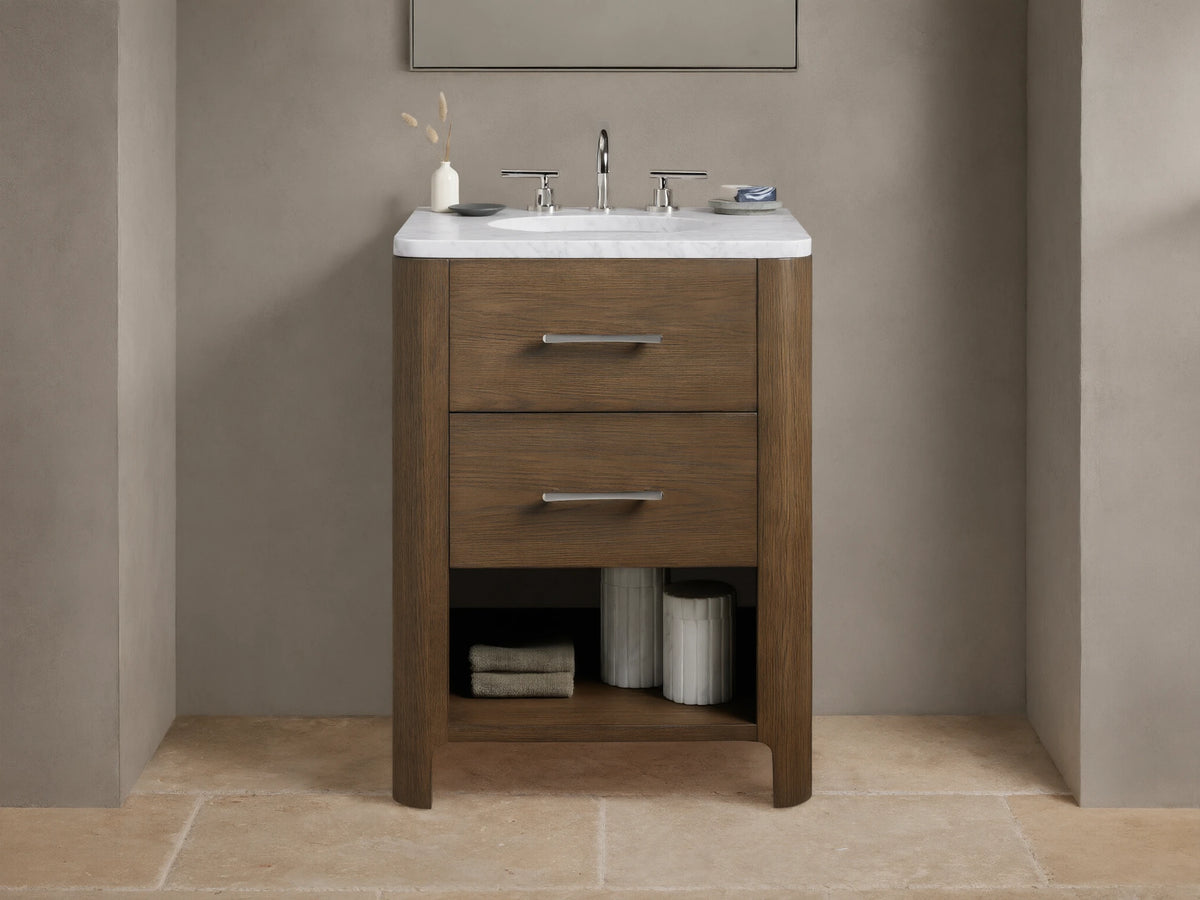 Calista Powder Vanity with oak frame, stone top, undermount sink, and two drawers, set in a neutral-toned bathroom scene.