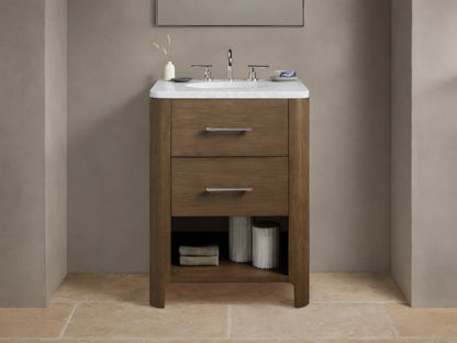 Calista Powder Vanity with oak frame, stone top, undermount sink, and two drawers, set in a neutral-toned bathroom scene.