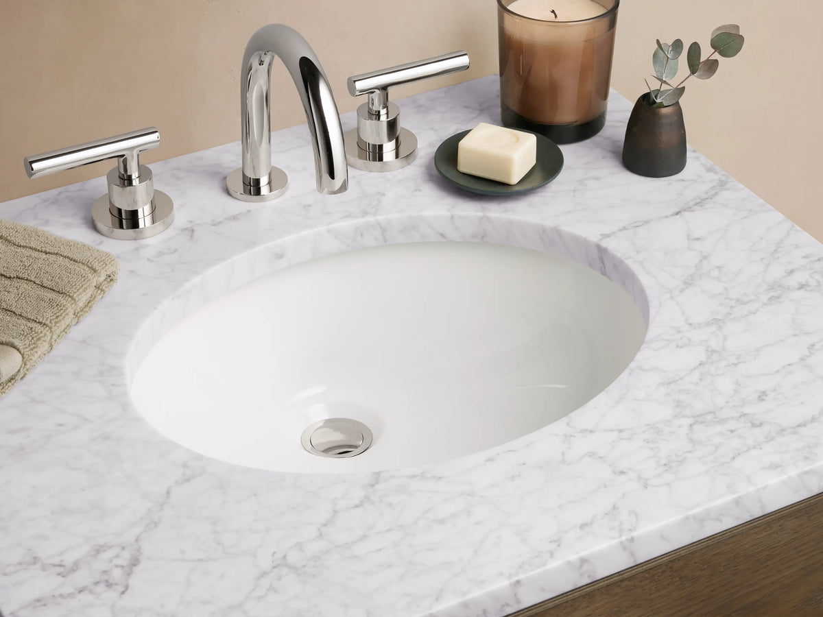 Calista Powder Vanity with oak finish, two drawers, and white stone top, featuring silver handles and an undermount sink.