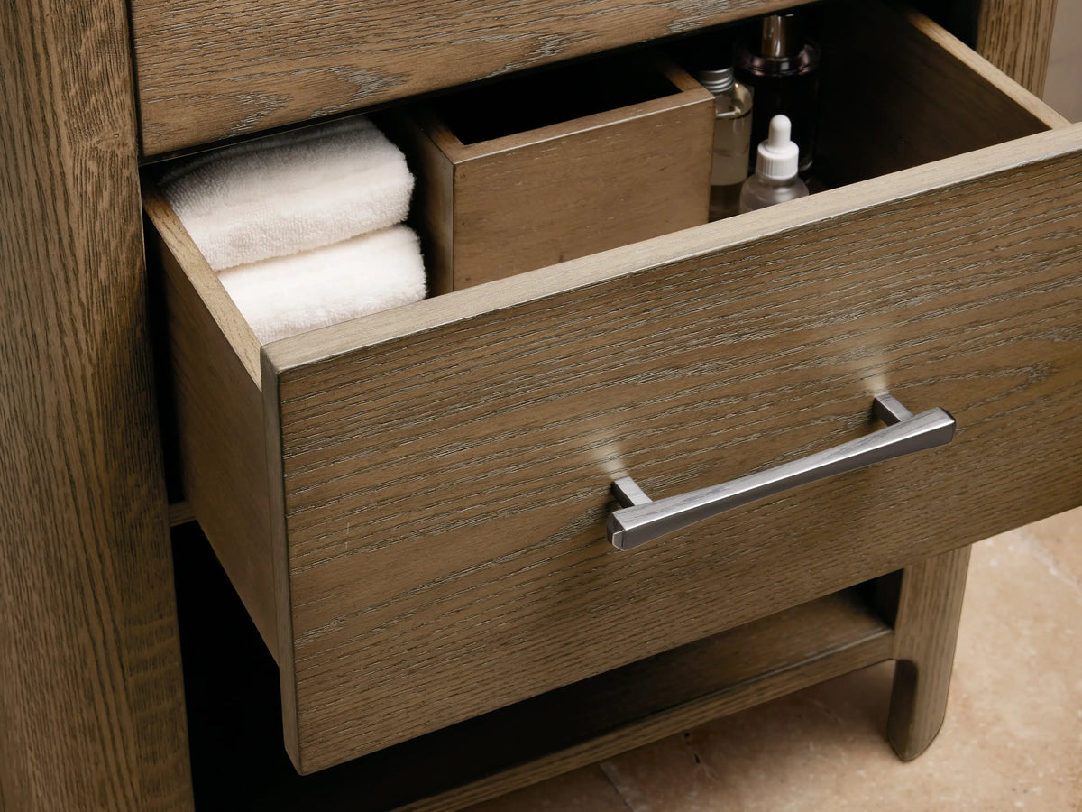 Calista Powder Vanity featuring an oval ceramic undermount sink on a Carrara marble top, with chrome faucet and soap dish.