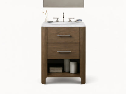 Calista Powder Vanity with oak frame, stone top, undermount sink, and two drawers, set in a neutral-toned bathroom scene.