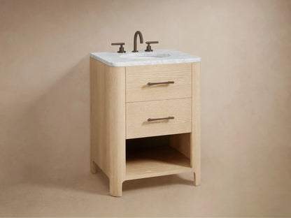 Open oak Calista Powder Vanity drawer with visible grain, white towel, wooden box, and toiletries. Features a dark bronze handle.